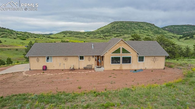 back of property featuring a mountain view