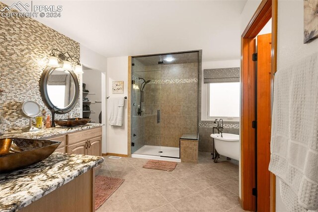 bathroom featuring vanity, tile walls, separate shower and tub, and tile patterned floors