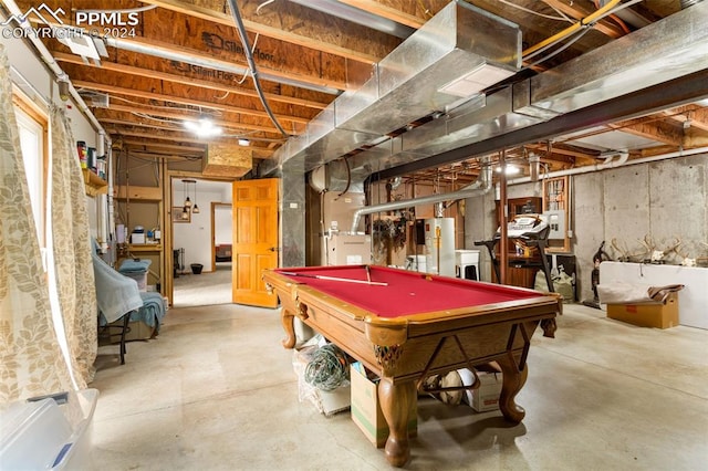 rec room featuring concrete floors, gas water heater, washer / clothes dryer, and billiards