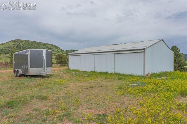 view of yard with an outdoor structure and a mountain view