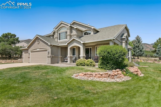 craftsman-style house with a garage, a front lawn, and covered porch