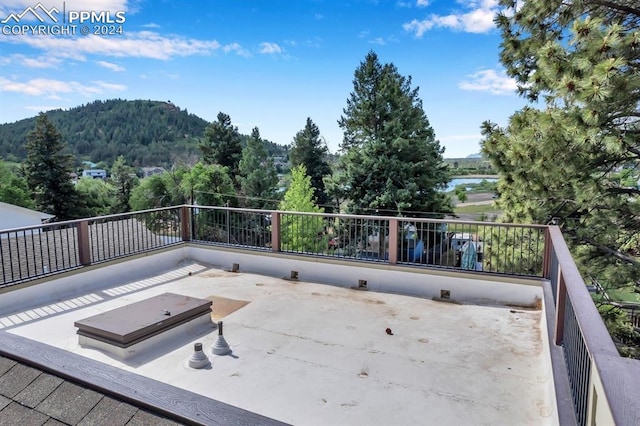 view of patio / terrace featuring a balcony and a water and mountain view