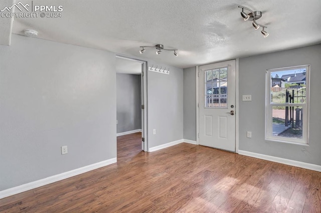 foyer featuring a textured ceiling and wood-type flooring