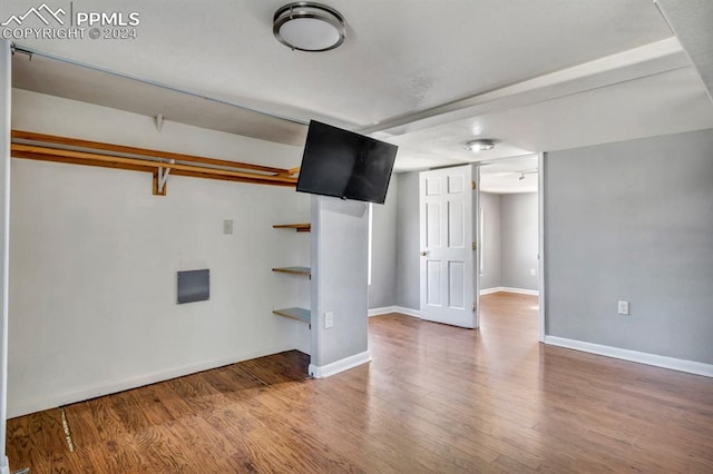 basement with hardwood / wood-style flooring