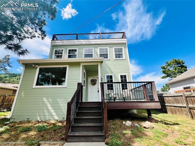 view of front of property featuring a wooden deck