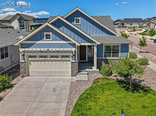 craftsman-style home featuring a front yard and a garage