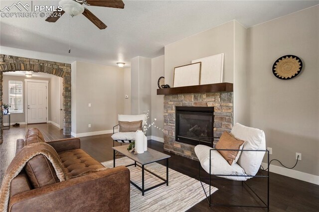 living room featuring a fireplace, ceiling fan, and hardwood / wood-style floors