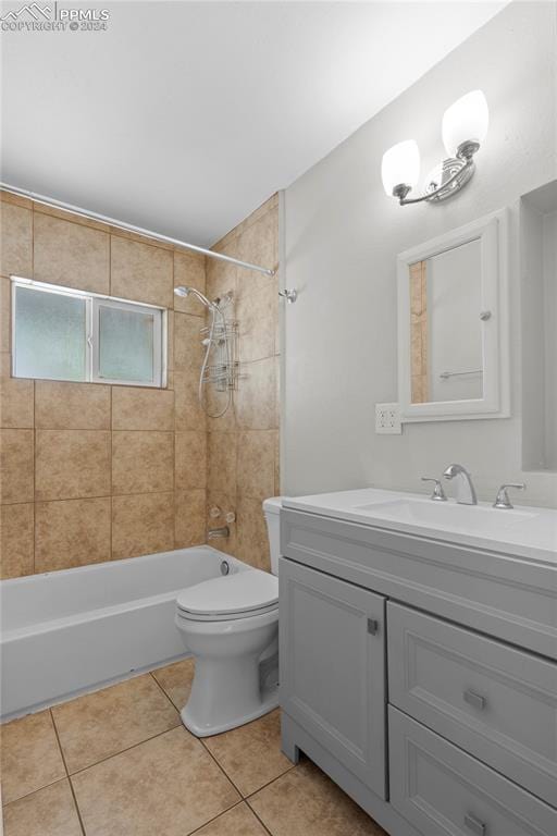 full bathroom with tile patterned floors, toilet, vanity, and tiled shower / bath