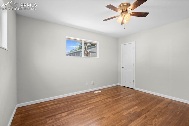 spare room with ceiling fan and wood-type flooring