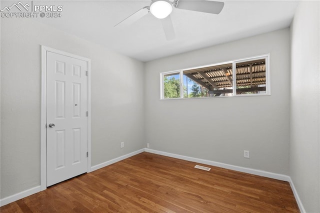 unfurnished room featuring hardwood / wood-style flooring and ceiling fan