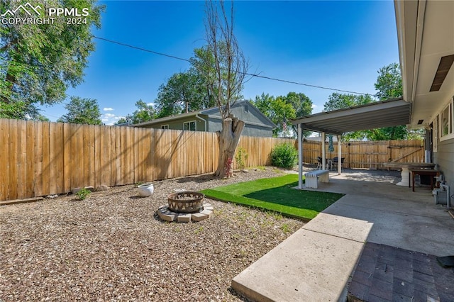 view of yard with a patio and an outdoor fire pit