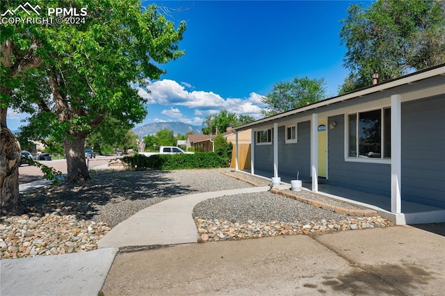 view of property exterior with a mountain view