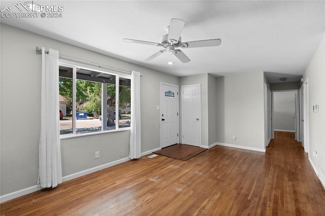 foyer entrance with hardwood / wood-style flooring and ceiling fan