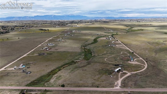 drone / aerial view with a mountain view and a rural view