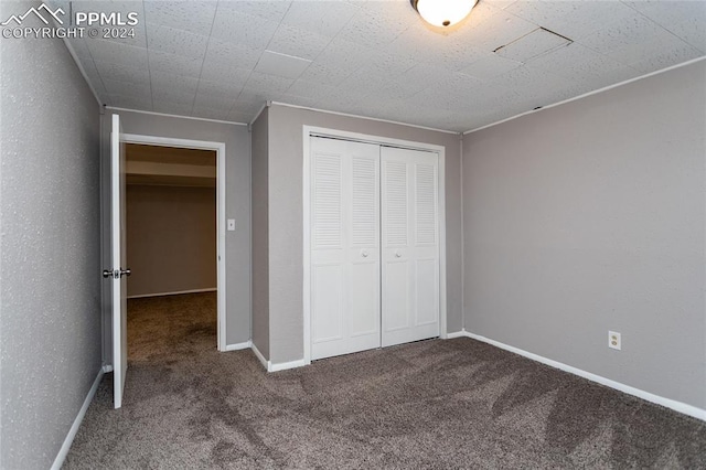 unfurnished bedroom featuring a closet and carpet floors