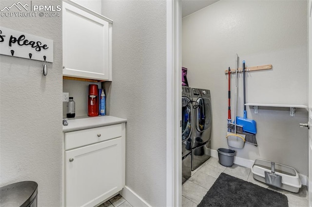 clothes washing area featuring washing machine and clothes dryer and light tile patterned floors