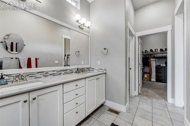 bathroom with decorative backsplash, dual vanity, and tile patterned floors