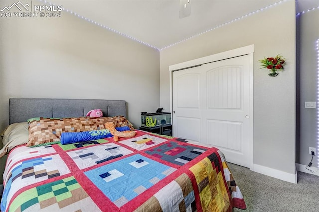 bedroom with ceiling fan, carpet, and a closet