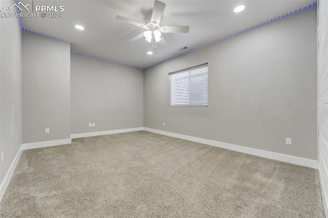 carpeted empty room featuring ceiling fan