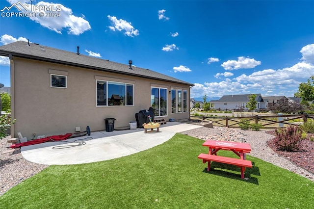 back of house featuring a patio area and a yard