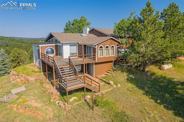 rear view of property with a wooden deck