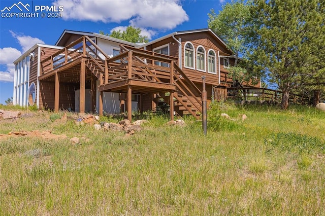 back of property with a wooden deck