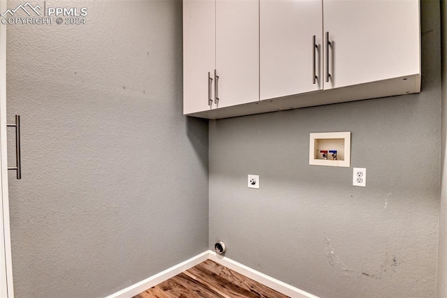 laundry room featuring hardwood / wood-style floors, hookup for a washing machine, cabinets, and hookup for an electric dryer