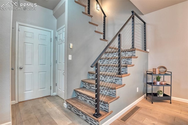 stairway featuring wood-type flooring