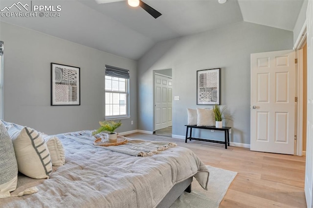 bedroom featuring vaulted ceiling, ceiling fan, and light wood-type flooring