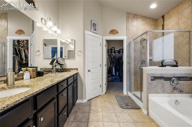 bathroom featuring plus walk in shower, lofted ceiling, tile patterned flooring, and dual bowl vanity