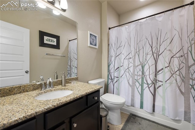 bathroom with tile patterned floors, vanity, and toilet