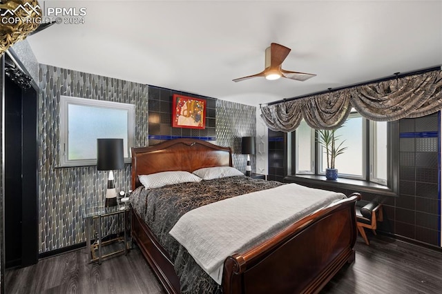 bedroom featuring multiple windows, hardwood / wood-style flooring, and ceiling fan