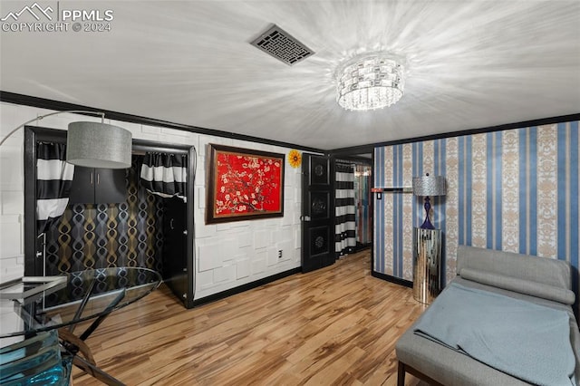 interior space with wood-type flooring and a notable chandelier