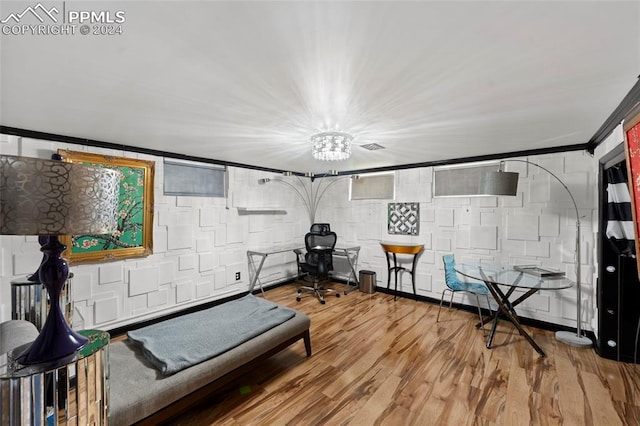 workout room featuring crown molding and hardwood / wood-style floors