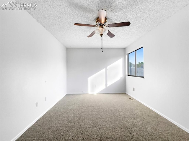 unfurnished room with carpet floors, a textured ceiling, and ceiling fan