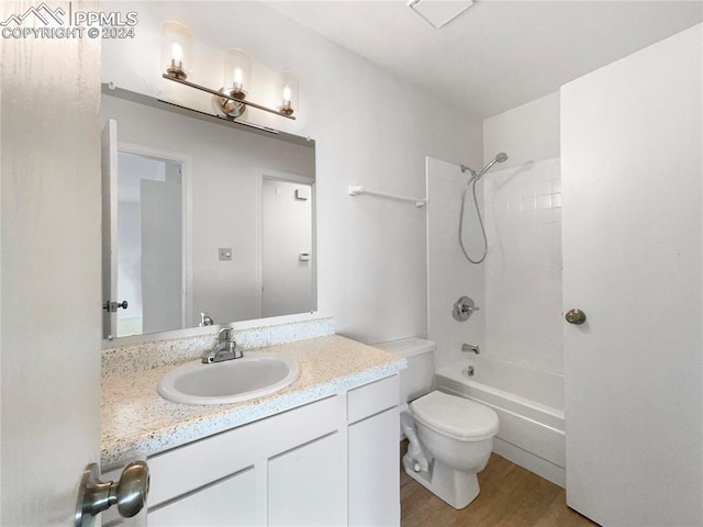 full bathroom with bathtub / shower combination, wood-type flooring, toilet, and vanity