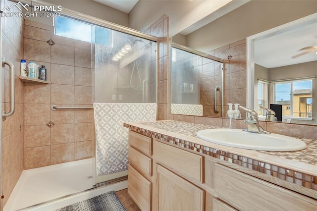 bathroom featuring vanity, plenty of natural light, and an enclosed shower