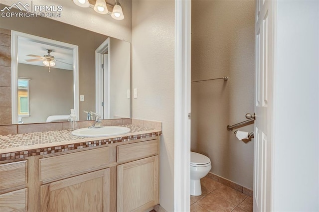 bathroom featuring tile patterned flooring, vanity, ceiling fan, and toilet