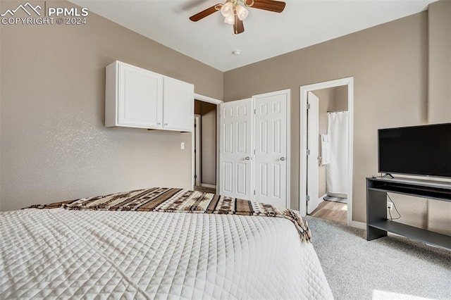 unfurnished bedroom featuring ceiling fan, light carpet, and ensuite bath