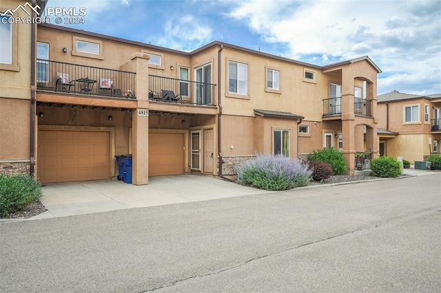 view of front of home featuring a garage and central AC