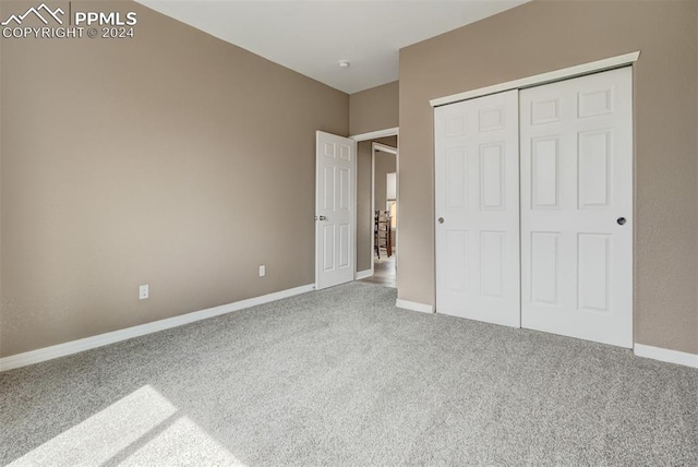 unfurnished bedroom featuring a closet and carpet