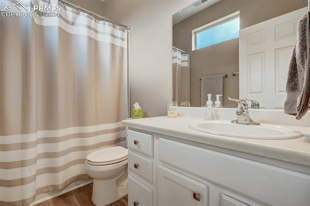 bathroom with vanity, hardwood / wood-style floors, and toilet