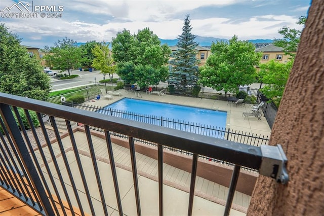 view of pool with a patio and a mountain view