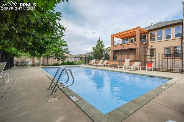 view of pool with a pergola and a patio