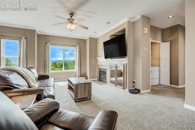 living room featuring ornamental molding, ceiling fan, and carpet flooring