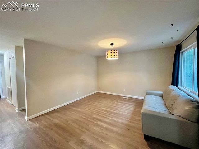 unfurnished room with hardwood / wood-style flooring