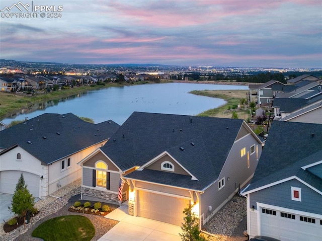 aerial view at dusk with a water view