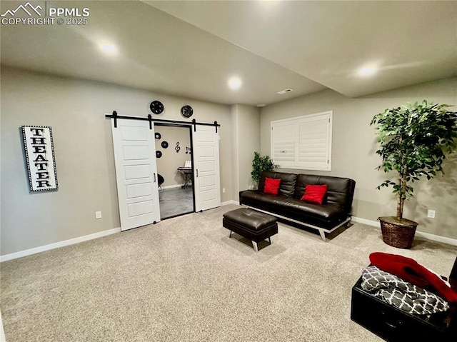 carpeted living room featuring a barn door