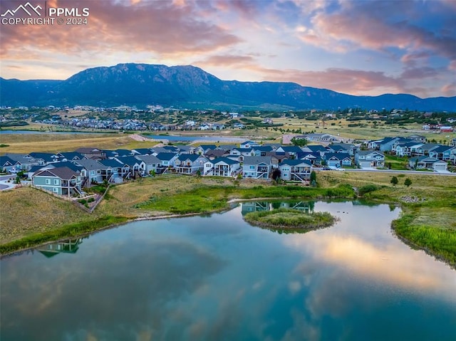 aerial view at dusk with a water and mountain view