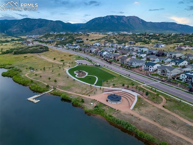 drone / aerial view with a water and mountain view